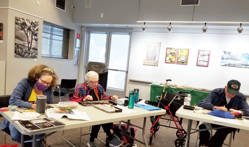 Darcy Lohmann, Katherine Miller and Al Meloche working on their art at a San Diego Chapter meeting in Pacific Beach.