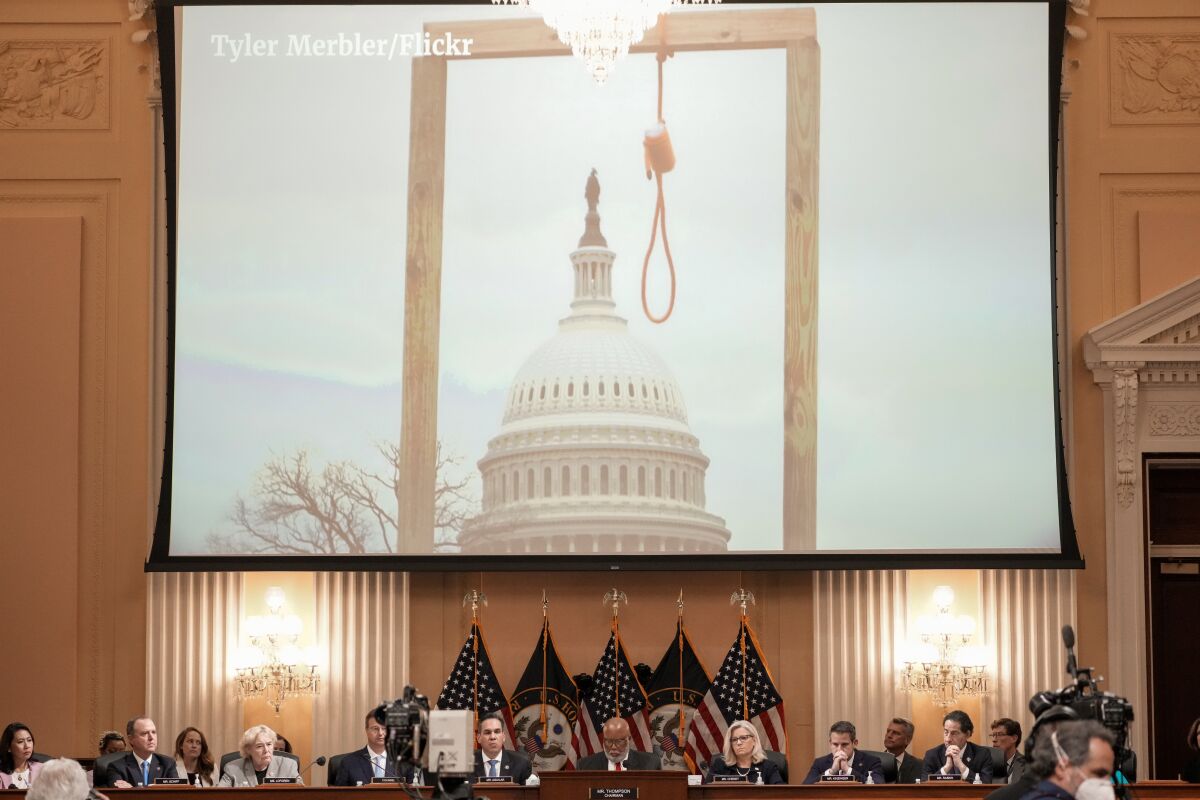 Photos from Jan. 6 are shown during the House Select Committee hearing.