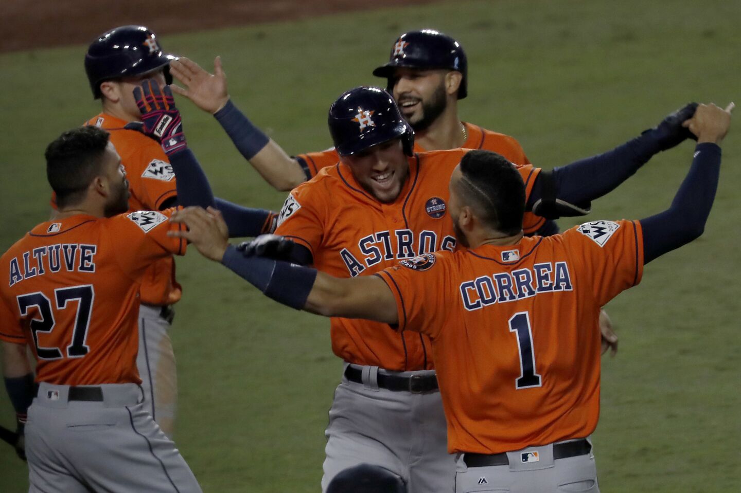 Astros right fielder George Springer, center, celebrates with teammates after hitting a two-run homer against the Dodgers in the second inning.