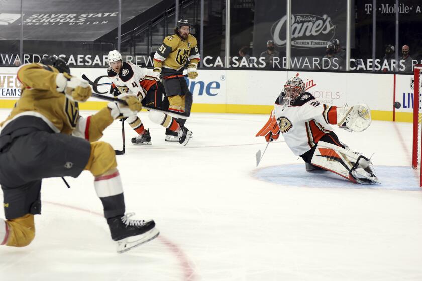 Vegas Golden Knights left wing Max Pacioretty, left, shoots and scores past Anaheim Ducks goalie Ryan Miller (30) during overtime in an NHL hockey game Saturday, Jan. 16, 2021, in Las Vegas. (AP Photo/Isaac Brekken)