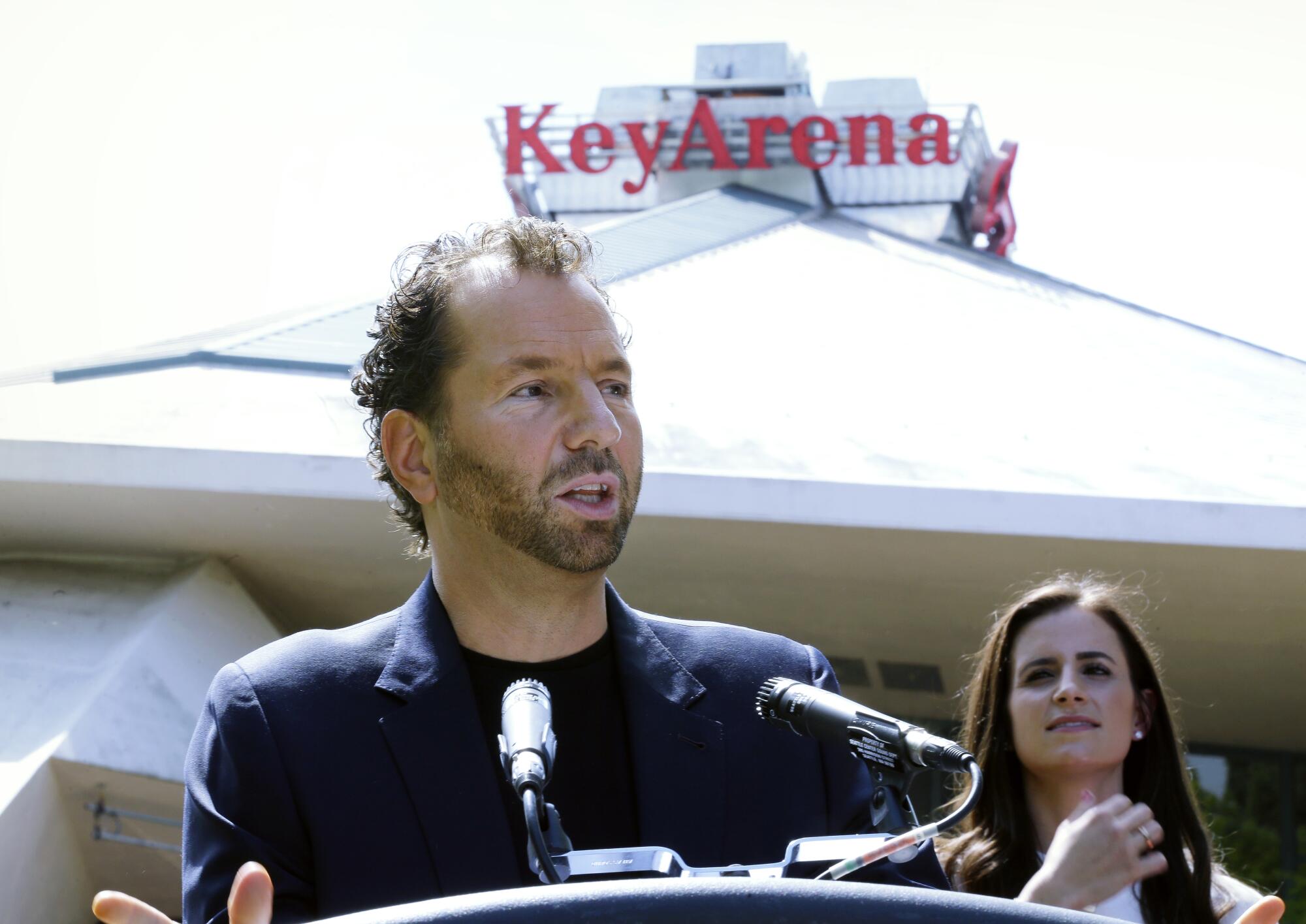 Michael Rapino, president and chief executive of Live Nation Entertainment, speaks outside an arena.