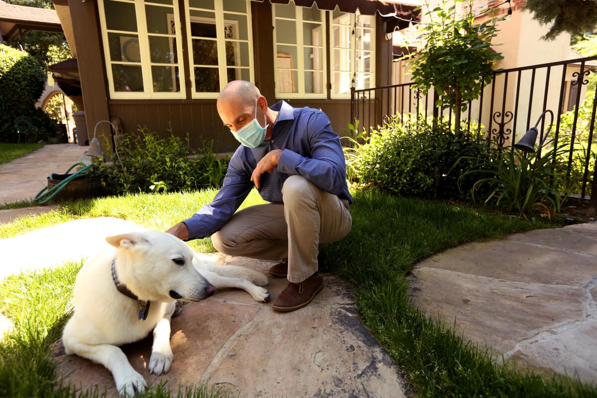 Dr. Steven Siegel, 55, a psychiatrist and chair of the Department of Psychiatry and Behavioral Studies with the Keck School of Medicine at USC, takes a break from working at home to spend time with his dog Philly.