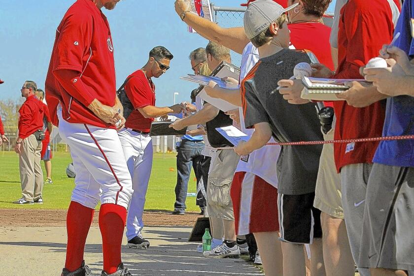 Stephen Strasburg, left, and Nationals teammate Gio Gonzalez in 2014 with fans in Viera, Fla.