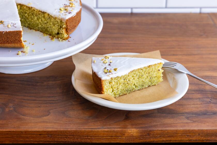 LOS ANGELES, CA - MARCH 14, 2024: A pistachio, olive-oil cake with lemon glaze and a topping of pistachios, sumac, coriander and fleur de sal from Valerie Confections by Valerie Gordon, a chocolatier, restaurateur, and the owner of the the bakery, stands on display at the store in Glendale on Thursday, Mar. 14, 2024. Gordon is celebrating the 20th anniversary of her business. (Silvia Razgova / For The Times)