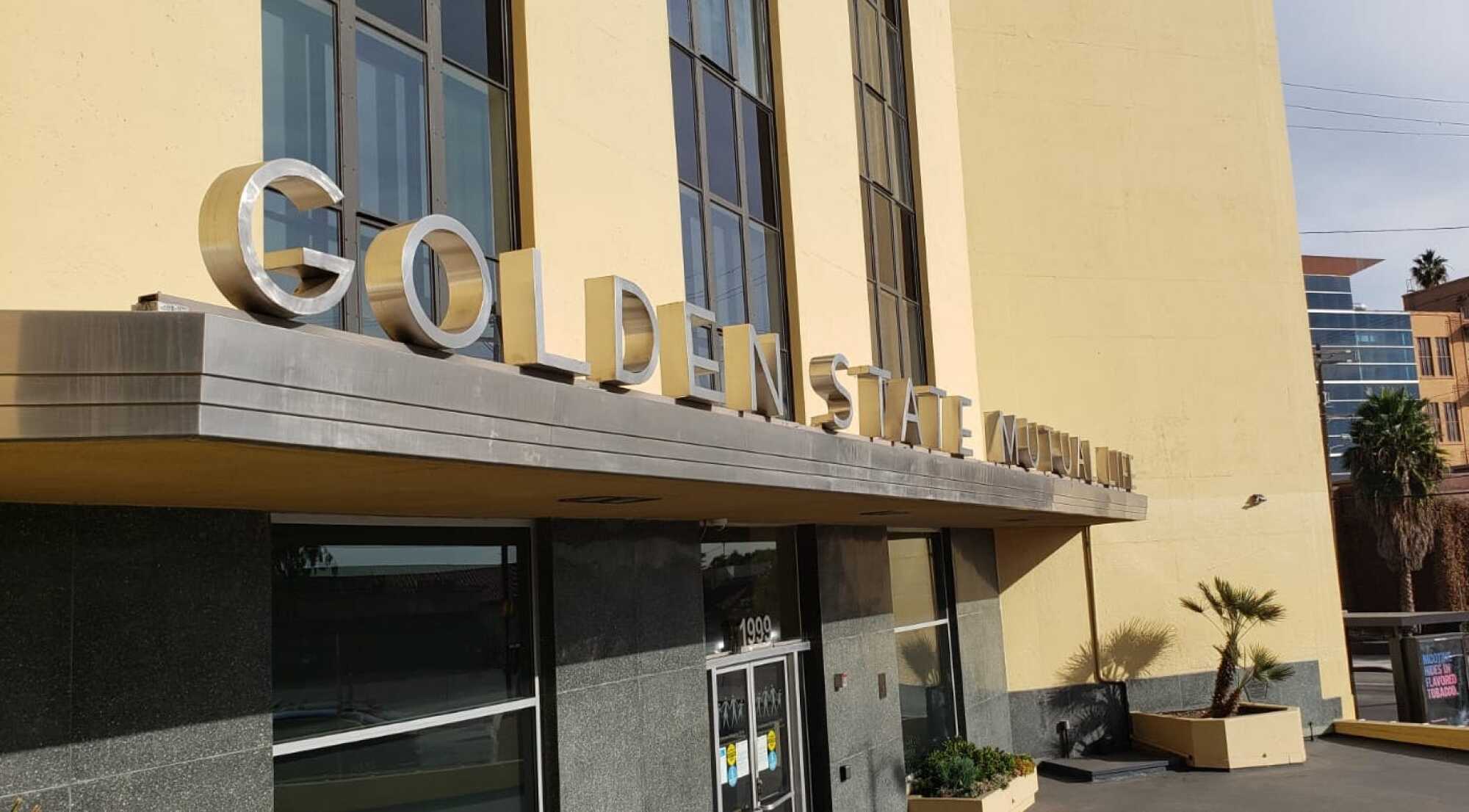 A side view shows a row of elegant Modernist letters spelling out the name of the Golden State Mutual Co.