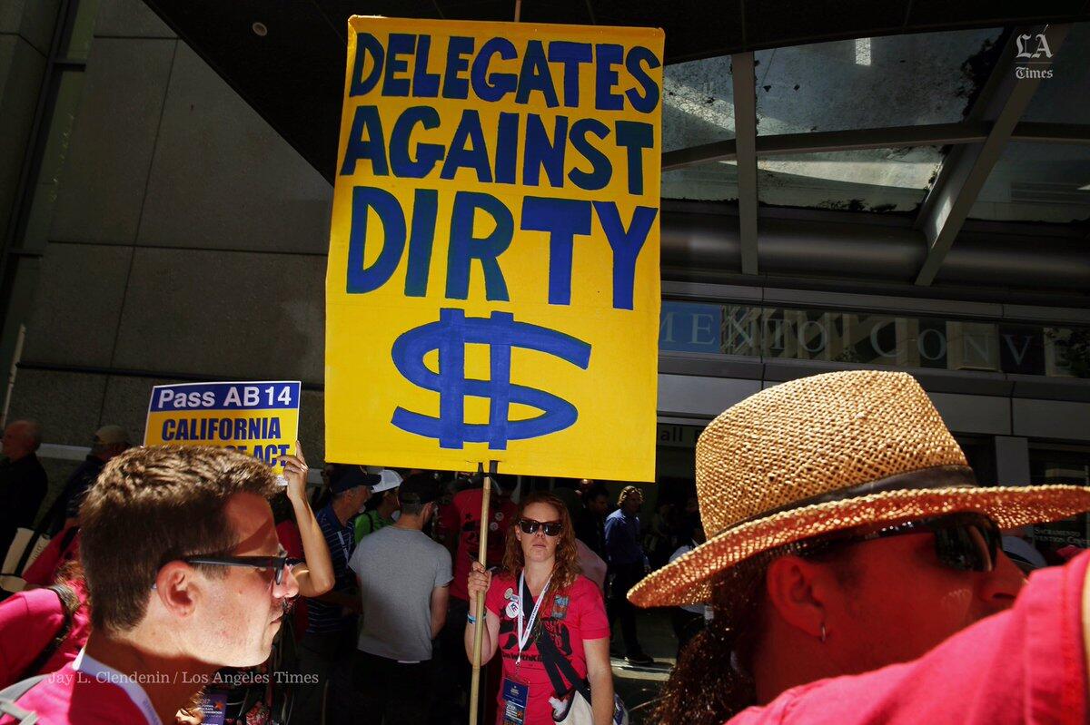 California Democratic Party delegate Nicole Lutkemuller of Tahoe City leads a march urging Democratic officials and candidates to stop taking money from oil companies.