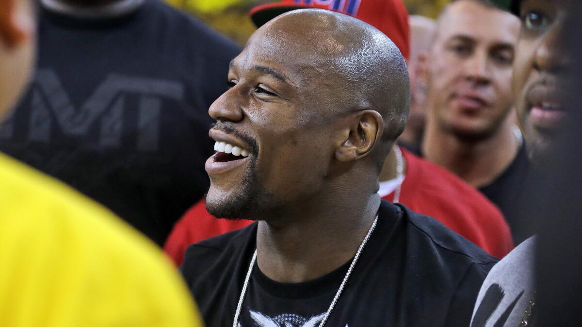 Floyd Mayweather Jr. smiles while attending Game 1 of the NBA Finals between the Golden State Warriors and Cleveland Cavaliers on June 4.