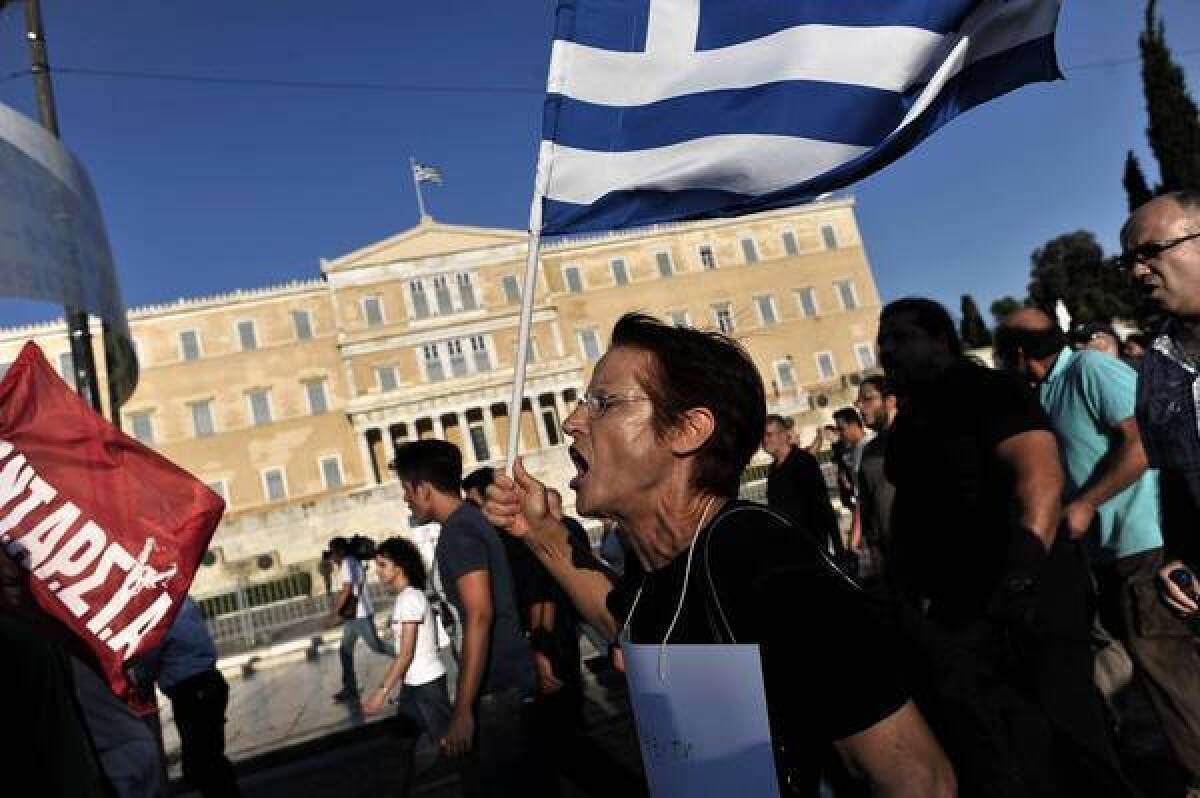 Protesters shout slogans against the visit of the German finance minister as they demonstrate in front of the Parliament building in central Athens in mid-July.