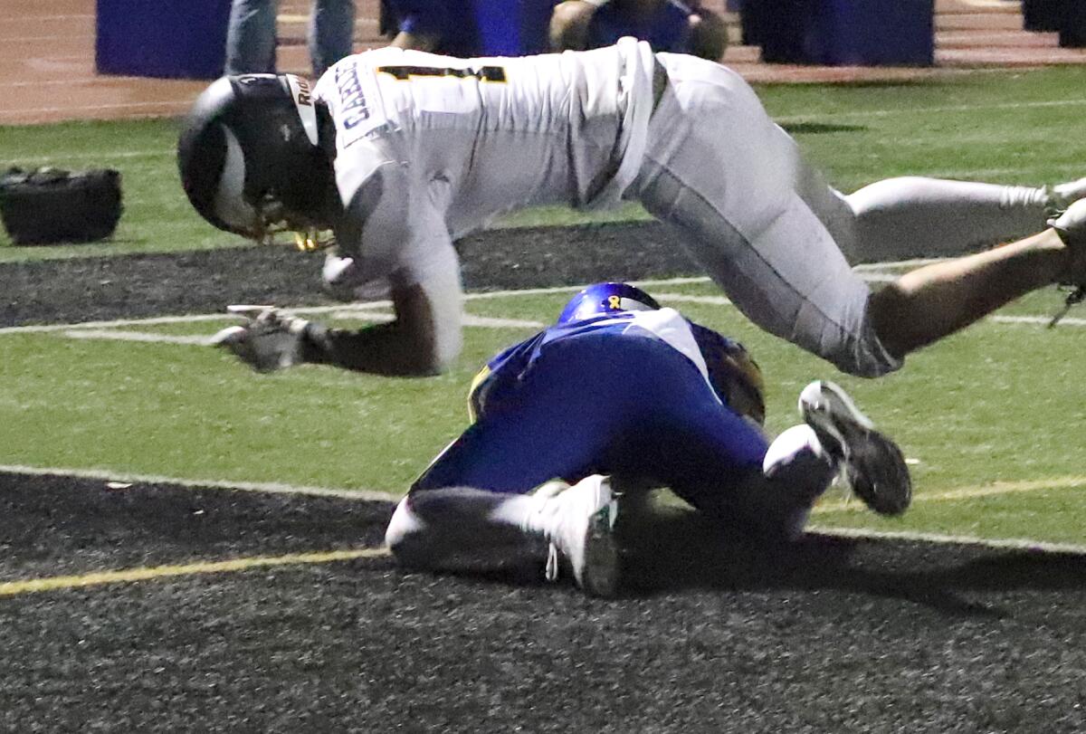 Marina's Gabe Carles dives into the end zone for a touchdown against Fountain Valley in a nonleague game.