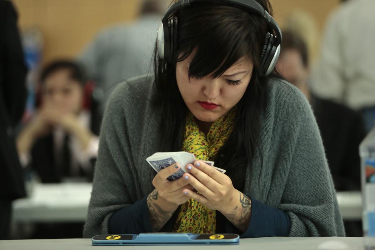 Sue Jin Yang was one of the few women competing in the 17th annual USA Memory Championship.She wears headphones to block out all of the distractions as she memorizes a deck of cards, which is one of the tests in the contest.