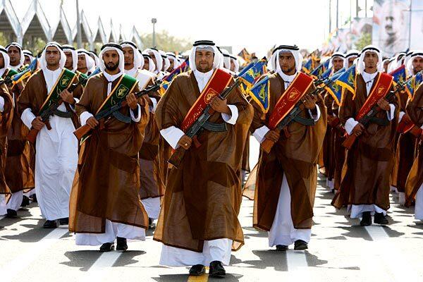 A group of Iranian Arabs, members of the Basij militia, which is affiliated with the Revolutionary Guard, march during a military parade at the mausoleum of the Ayatollah Khomeini outside Tehran marking the 29th anniversary of the start of the 1980-1988 Iraq-Iran war.