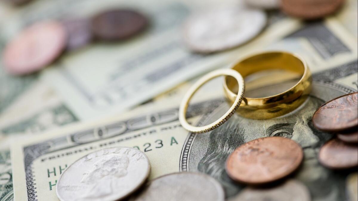 Closeup of wedding rings with money