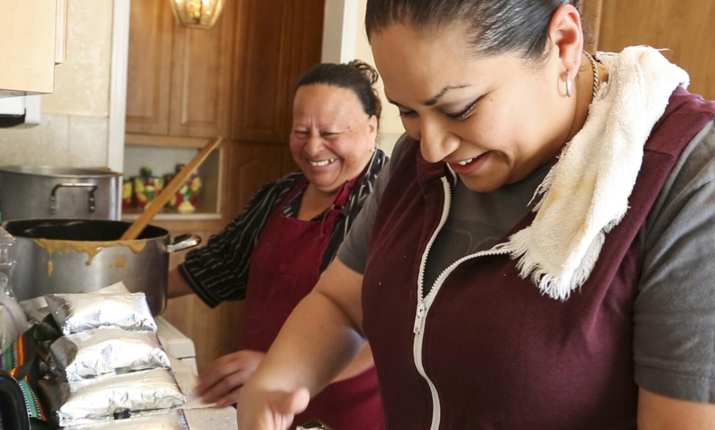 Dora Gonzalez, left, and her daughter, Cynthia, get together in the family kitchen in Inglewood to make Salvadoran tamales from a family recipe passed down for generations.