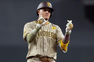 San Diego Padres' Manny Machado motions towards his dugout after an RBI base hit against the Arizona Diamondbacks during the first inning of a baseball game, Saturday, May 4, 2024, in Phoenix. (AP Photo/Matt York)