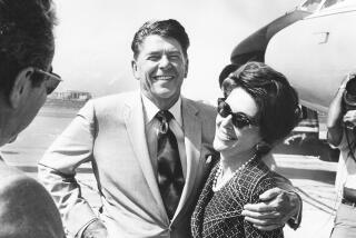 Mr. and Mrs. Ronald Reagan stand in front of jet bound for Europe at LAX terminal. 07–02–72