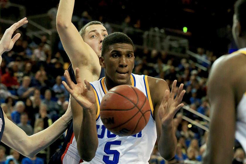 Bruins forward Kevon Looney dishes an assist to teammate Isaac Hamilton against Gonzaga on Saturday night at Pauley Pavilion.