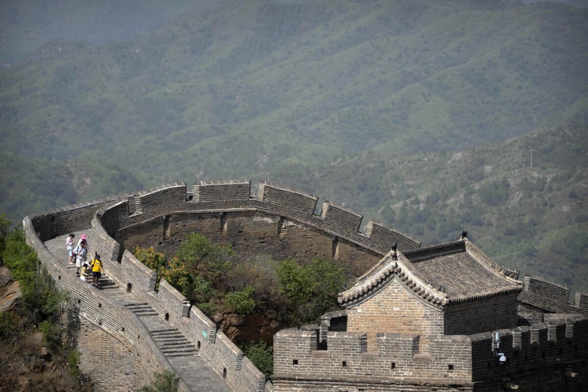 Vistors walk along the Great Wall of China.