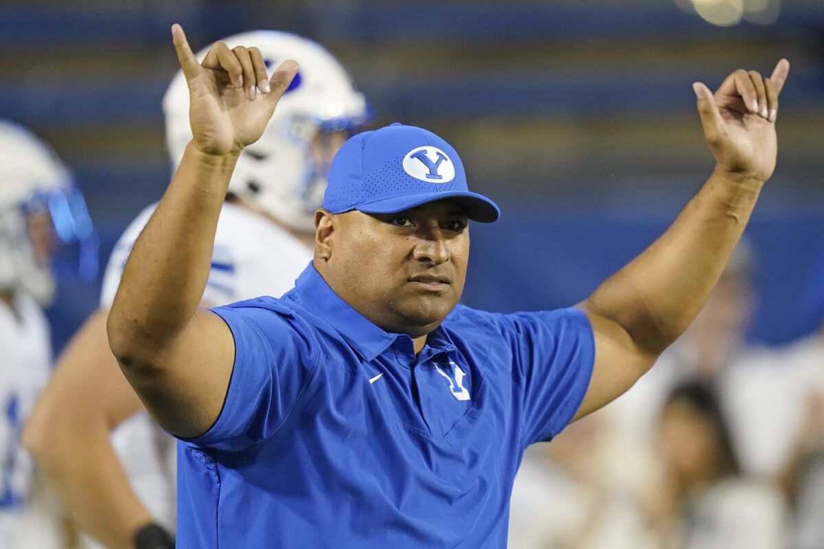 FILE - BYU coach Kalani Sitake gestures before the team's NCAA college football game against Arizona State in Provo, Utah, in this Saturday, Sept. 18, 2021, file photo. Sitake knows his players are looking forward to the change of scenery, the chance to try some different foods and a game in a different region of the country. The Cougars (5-1), who have played as a football independent since 2011, last month accepted an invitation to join the Big 12 and will begin play in that conference in two seasons. (AP Photo/Rick Bowmer, File)