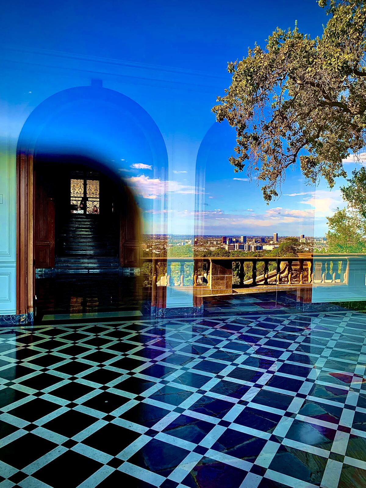 A scenic view reflected in the windows of Greystone Mansion in Beverly Hills