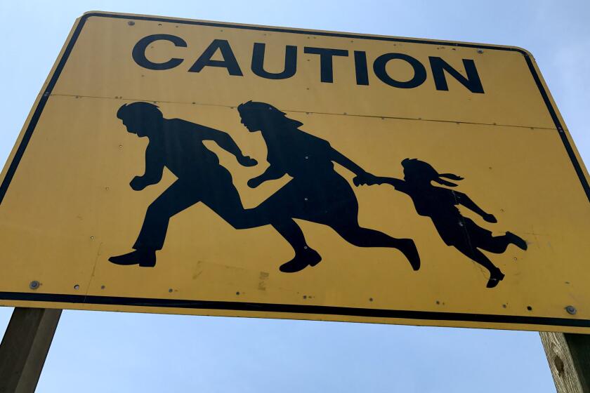 SAN YSIDRO CA JUNE 8, 2017 -- Only one of the ten iconic Caltrans caution signs emblazoned with the image of an immigrant father, mother and daughter running for their lives that once dotted the 5 Freeway is left.