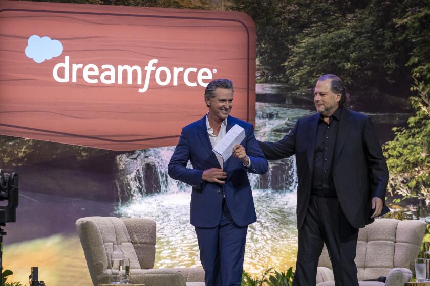 Gavin Newsom, governor of California, left, and Marc Benioff, chief executive officer of Salesforce Inc., during the 2024 Dreamforce conference in San Francisco, California, US, on Tuesday, Sept. 17, 2024. Newsom said he is concerned about a potential "chilling effect" on the development of artificial intelligence posed by a bill to regulate the new technology passed by the state legislature. Photographer: David Paul Morris/Bloomberg via Getty Images