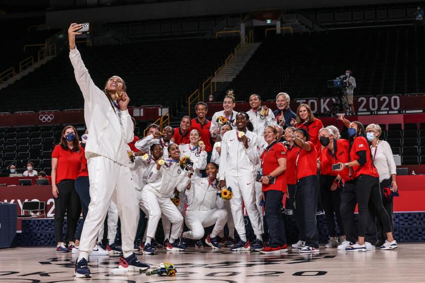 Tokyo, Japan, Sunday, August 8, 2021 - Team United States centre Brittney Griner (15) takes a selfie with Team USA after beating Japan in the Tokyo 2020 Olympics Women's Basketball Final at Saitama Super Arena. (Robert Gauthier/Los Angeles Times)