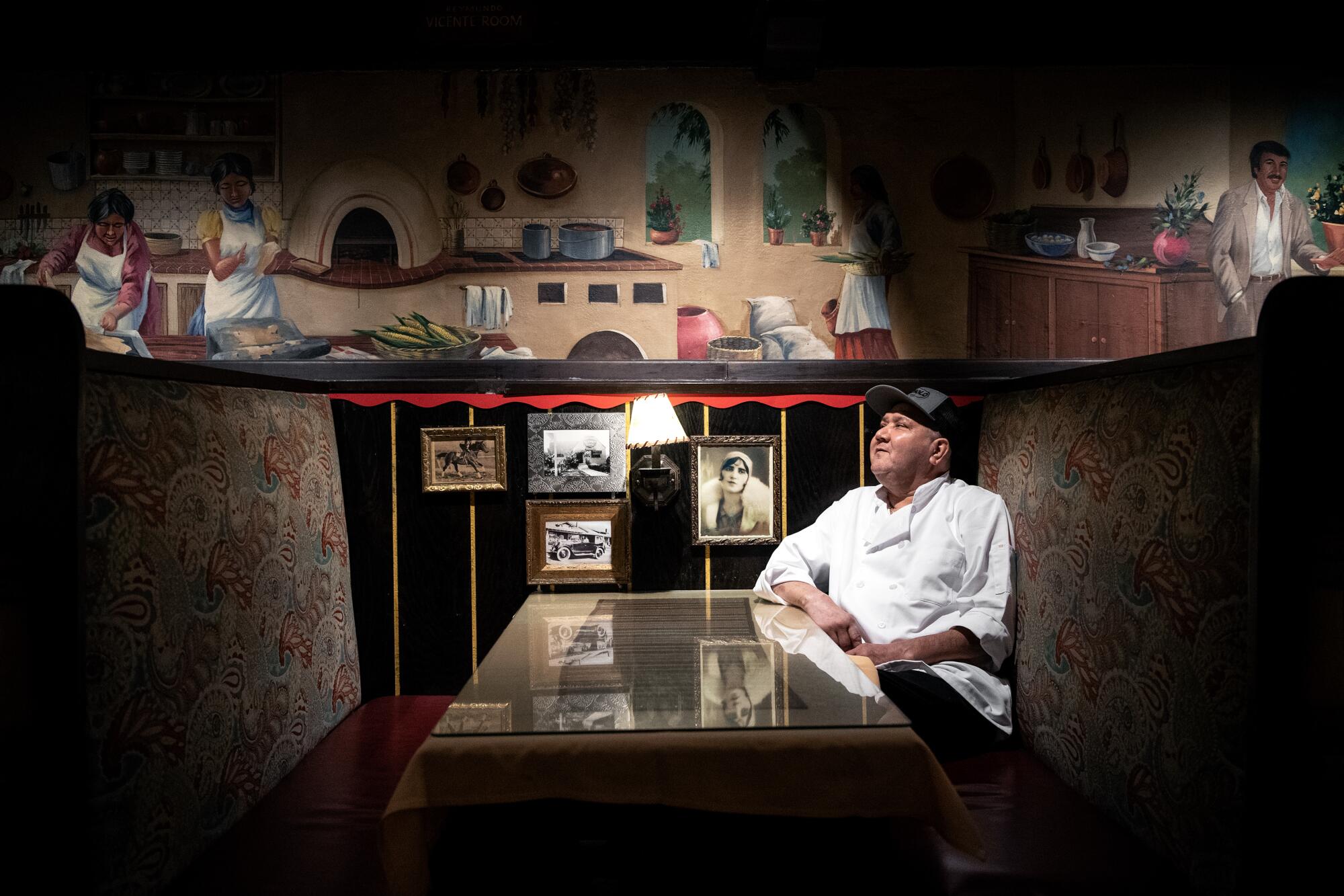 Moises Torres sitting in a booth at El Cholo restaurant.