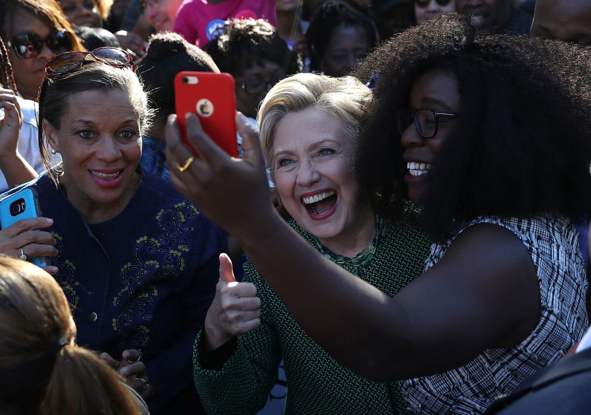 Hillary Clinton takes a selfie with early voters at Chavis Community Center in Raleigh, N.C., on Sunday. The contest in North Carolina remains close, and Clinton is depending on a large turnout of black voters.