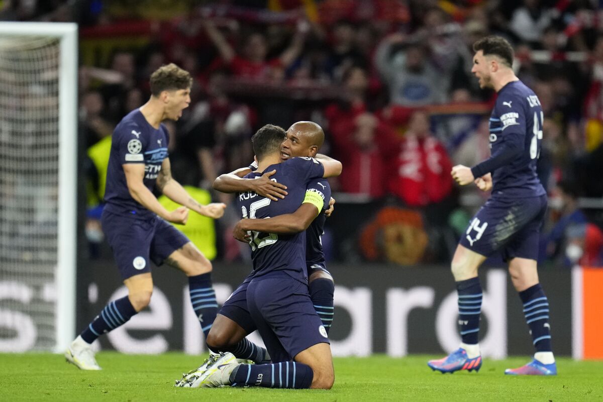 Manchester City's Fernandinho, right, and Manchester City's Rodrigo celebrate after the Champions League quarterfinal second leg soccer match between Atletico Madrid and Manchester City at Wanda Metropolitano stadium in Madrid, Spain, Wednesday, April 13, 2022. (AP Photo/Manu Fernandez)