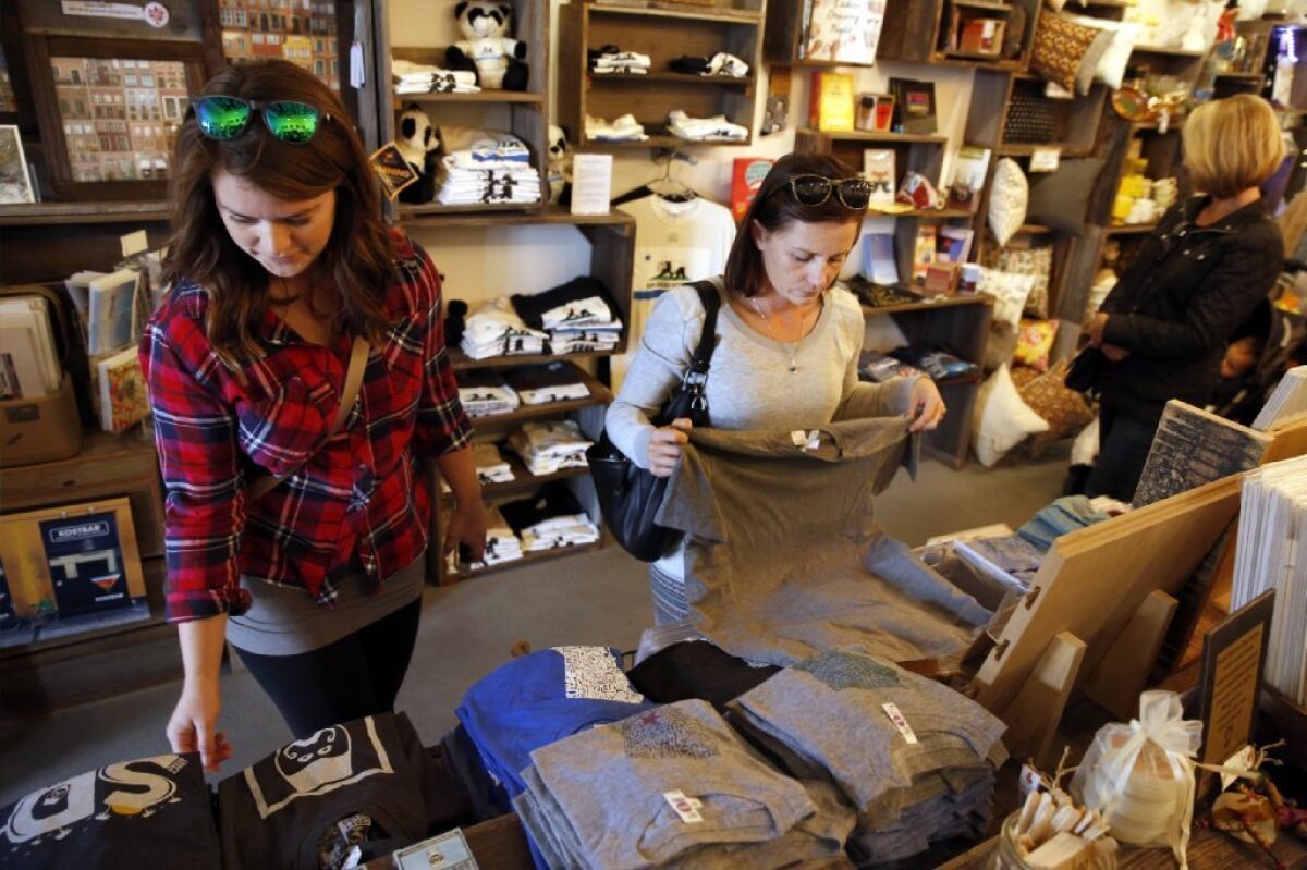 Rachel Webb, left, and Shelby Peters browse the goods at Simply Local.