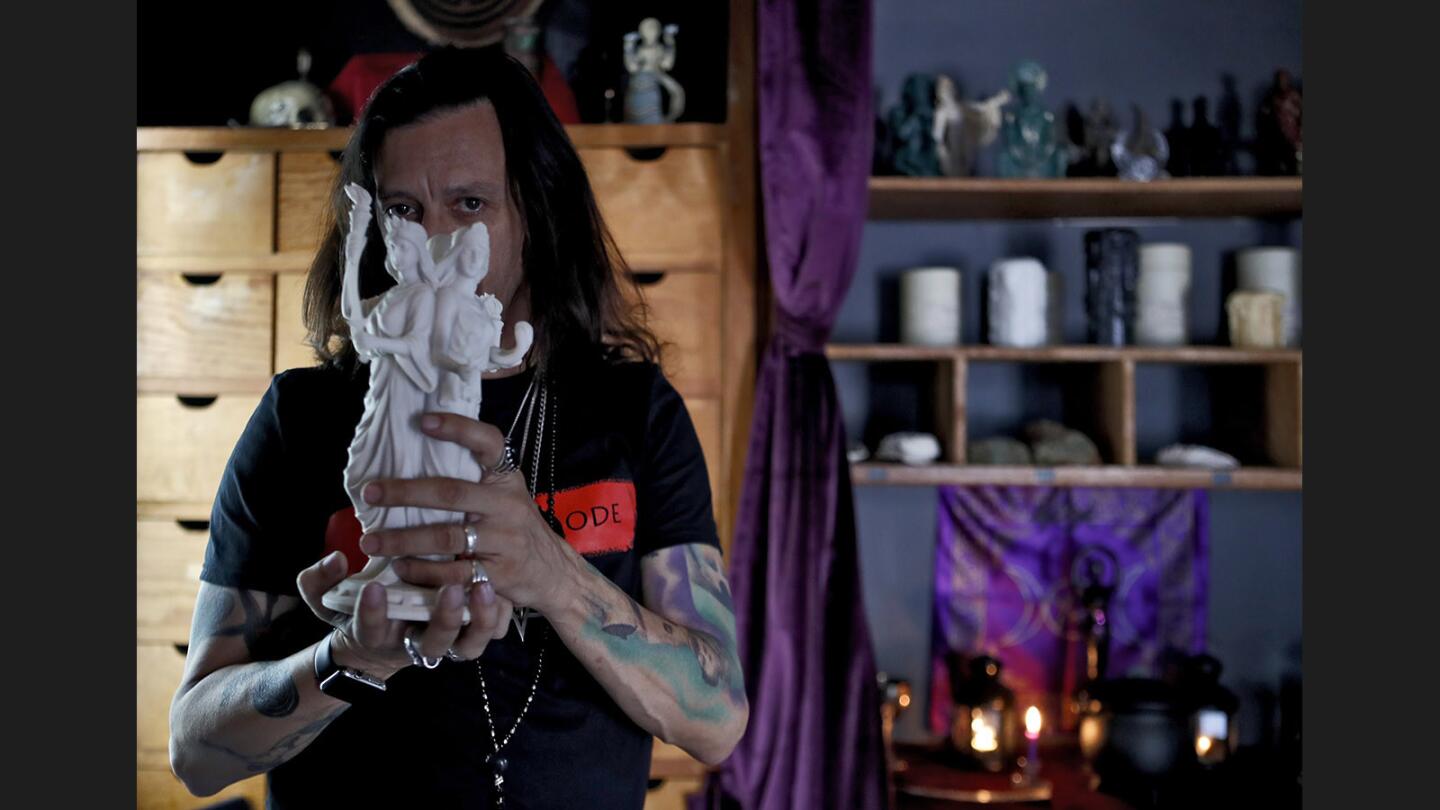 Occultist Sal Santoro, owner of The Crooked Path, an occult apothecary store, shows a statue of Hecate, at his store on Magnolia Ave., in Burbank, on Friday, October 13, 2017. Santoro invites everyone to come in and look around the store, ask questions and learn about the items in his store.
