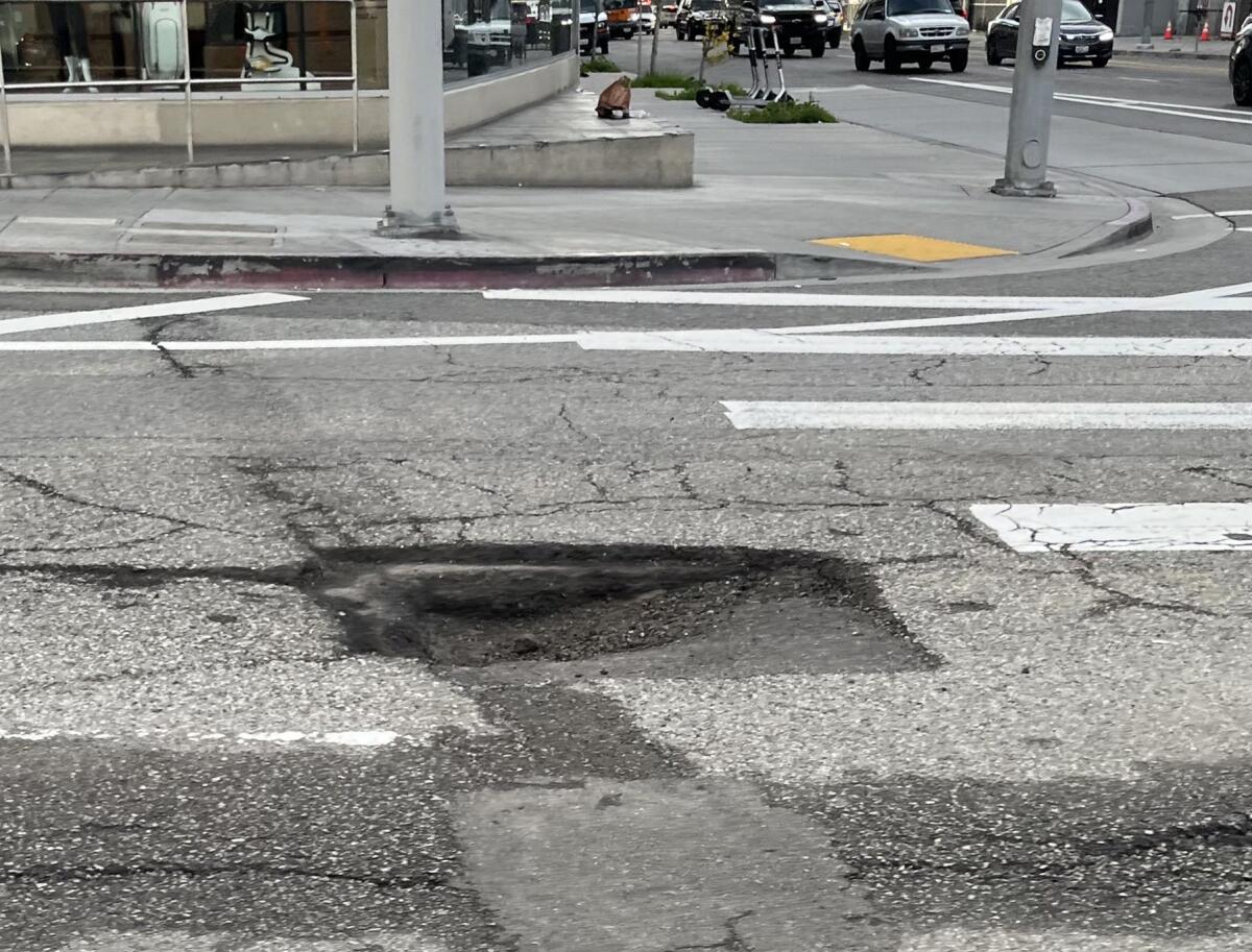 A wide and deep pothole at Western and Sixth St. in Los Angeles on January 12, 2023.