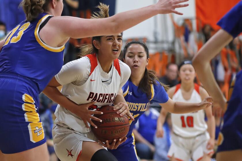 Annika Jiwani drives to the basket on Louisville's Katherine Csiszar, left, in the CIF Southern Section Division 5A girls' basketball championship game at Pacifica Christian High on Thursday.