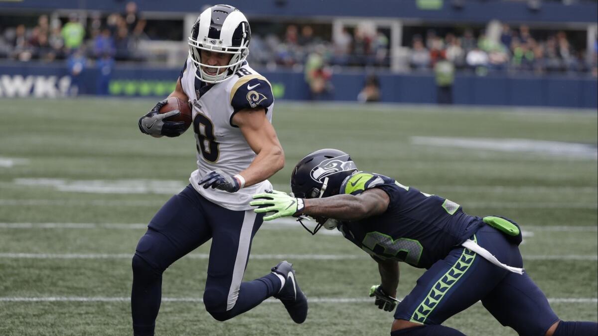 Rams wide receiver Cooper Kupp avoids a tackle by Seattle Seahawks free safety Tedric Thompson during the first half of an Oct. 7 game in Seattle.