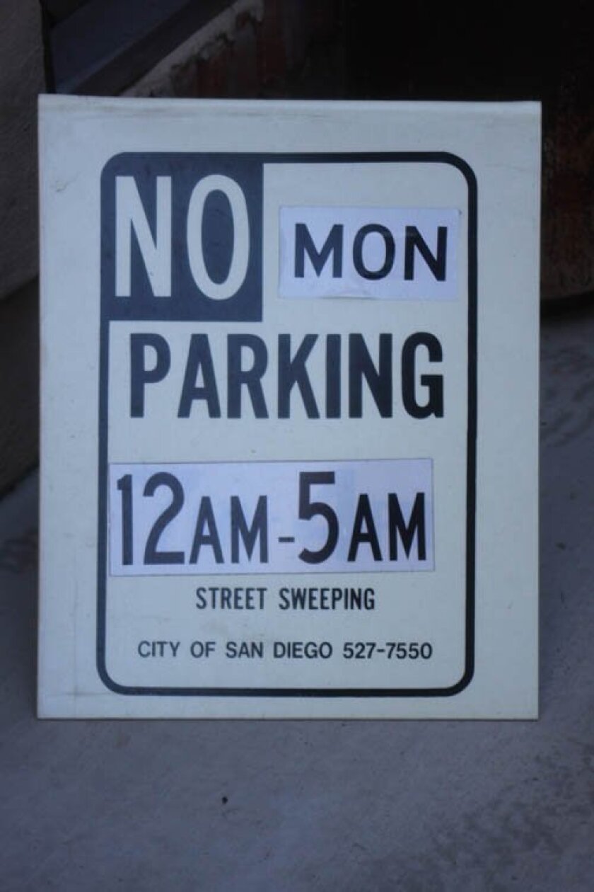 La Jolla resident Edward Nigolian posts these signs on his street hoping neighbors will move their cars to ensure thorough street sweeping. Ashley Mackin