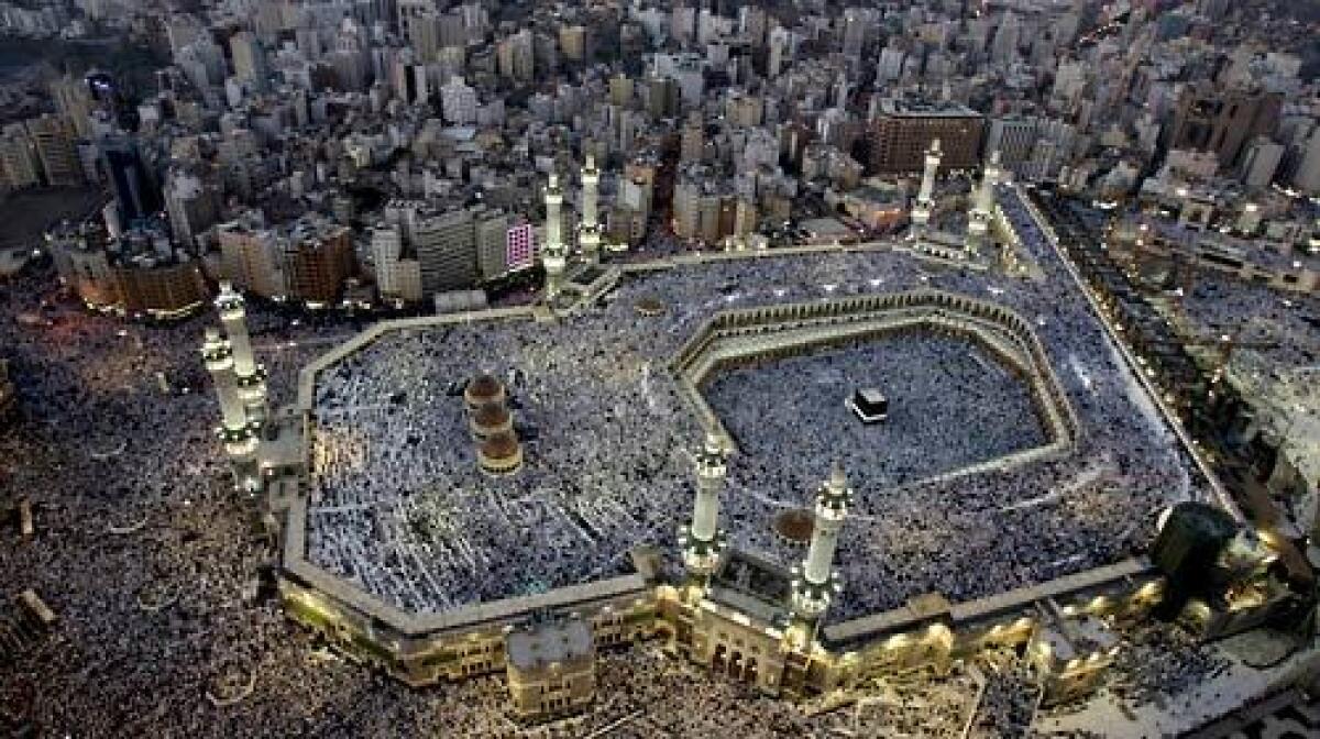 Pilgrims from all over the world fill the three levels of Mecca's Grand Mosque for prayers at sunset in the days before the hajj. The black cube-shaped building in the mosque is the Kaaba, built by the prophet Abraham.