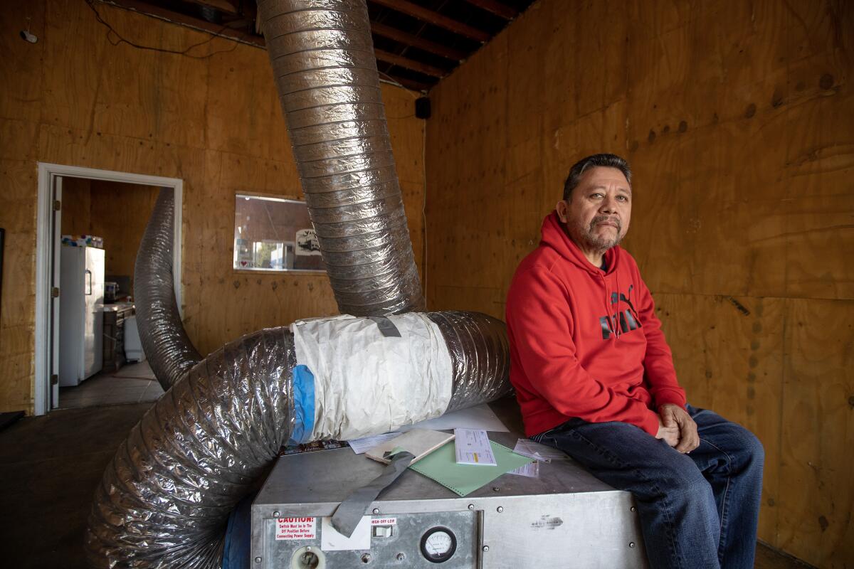 A man sits next to a machine