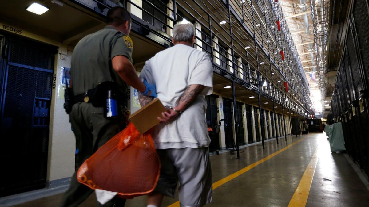 A death row inmate is escorted back to his cell after spending time in the yard at San Quentin State Prison in August 2016.