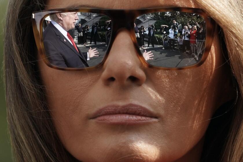 President Donald Trump's reflections are seen in the first lady Melania Trump's sunglasses as the president stops to answers questions on at South Lawn of the White House in Washington, Sunday, Sept. 10, 2017. (AP Photo/Pablo Martinez Monsivais)