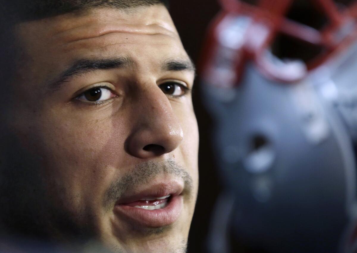 HOLD FOR STORY BY WILLIAM J. KOLE — FILE - In this Sept. 5, 2012 file photo, New England Patriots tight end Aaron Hernandez speaks in the locker room at Gillette Stadium in Foxborough, Mass. More than two years after he hanged himself in his prison cell in April 2017, while serving a life sentence for a 2013 murder, Netflix is releasing "Killer Inside: The Mind of Aaron Hernandez" on Jan. 15, 2020. Hernandez's suicide came just a days after he was acquitted of most charges in another double murder case. (AP Photo/Elise Amendola, File)