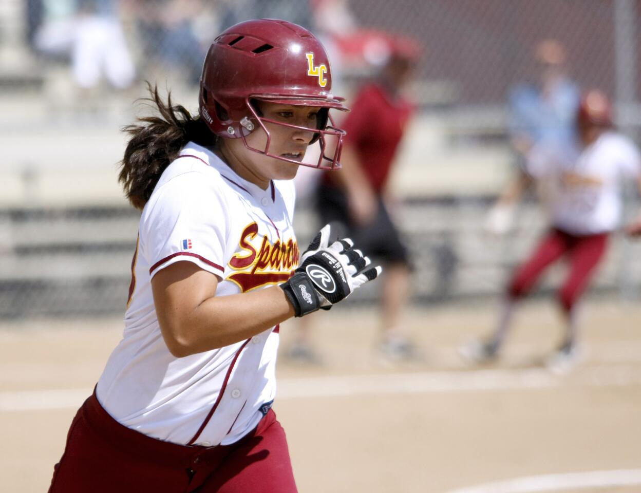 La Canada High's #20 Olivia Lam races to first base in CIF SS Div. IV sofball playoff game vs. Hawthorne High School at home in La Canada Flintridge on Tuesday, May 20, 2014.