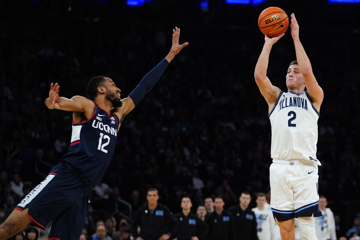 Villanova's Collin Gillespie (2) shoots over Connecticut's Tyler Polley (12) during the first half of an NCAA college basketball game in the semifinal round of the Big East conference tournament Friday, March 11, 2022, in New York. (AP Photo/Frank Franklin II)