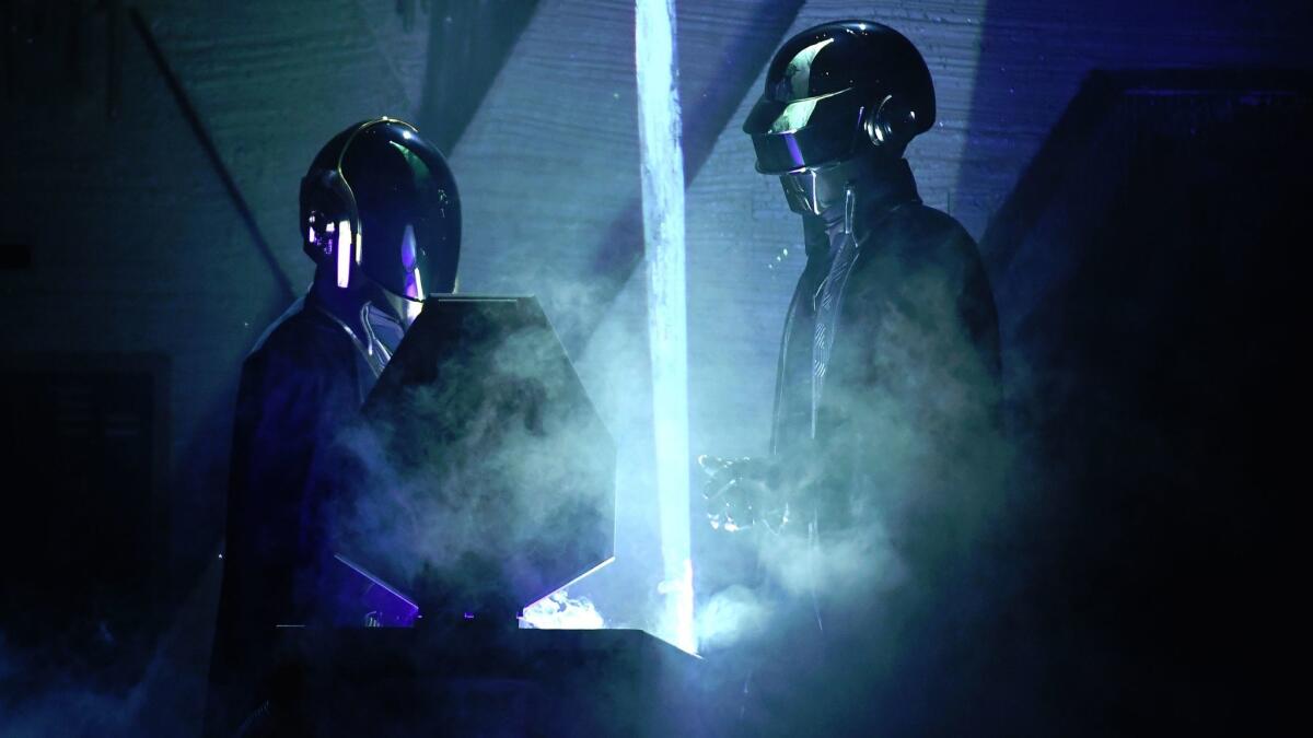 Daft Punk back the Weeknd during the 59th Grammy Awards.