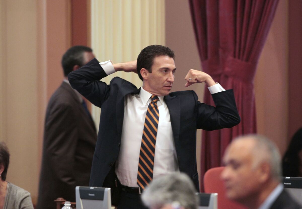 Former State Senator Michael Rubio, D¿Bakersfield, stretches during a lull in the legislative action at the Capitol last August.