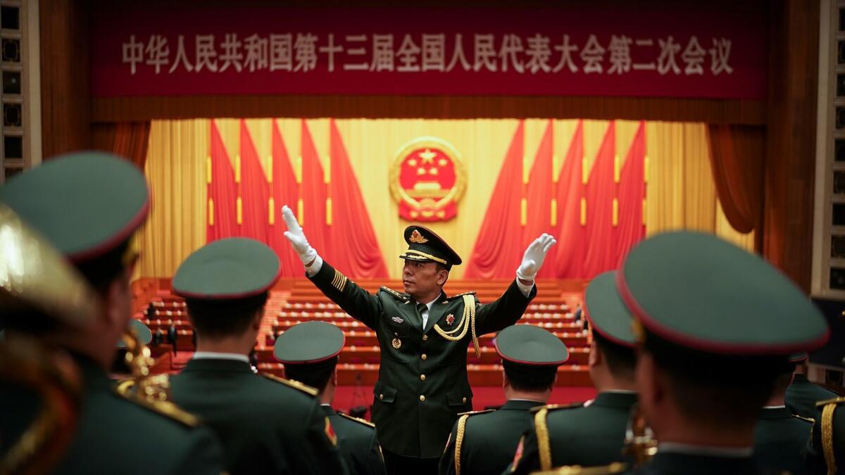 A Chinese military conductor instructs his band during a rehearsal for the opening session of the National People's Congress at the Great Hall of the People on March 5 in Beijing.