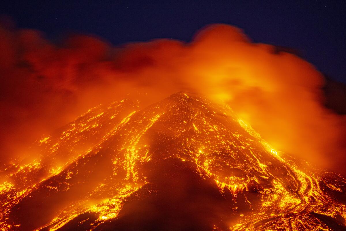 Lava gushes from the Mt Etna volcano near Catania, Sicily, Tuesday, Feb. 16, 2021. Europe's most active volcano came alive around 4 pm local time on Tuesday, according to the Italian Institute of Geophysics and Volcanology. (AP Photo/Salvatore Allegra)