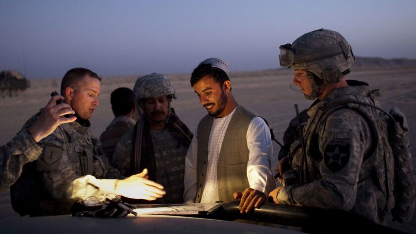 Abdul Raziq, then the border police commander for southern Afghanistan, meets with U.S. soldiers during a joint patrol in 2009.