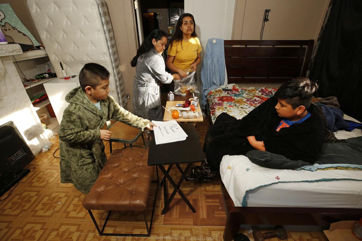 Raquel Lezama at home with her children. Her family struggles for its financial survival during the coronavirus pandemic. 