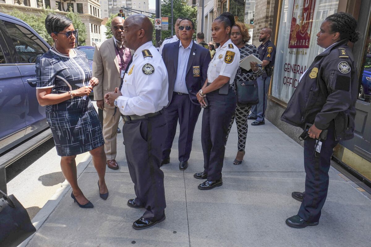 Atlanta Mayor Keisha Lance Bottoms, left, with Atlanta Police Chief Rodney Bryant, said two officers were "ambushed" while responding to a report of a shooting in a building in the city's Midtown area in Atlanta, Wednesday, June 30, 2021. The officers returned fire, killing one suspect, police said. (Ben Gray/Atlanta Journal-Constitution via AP)