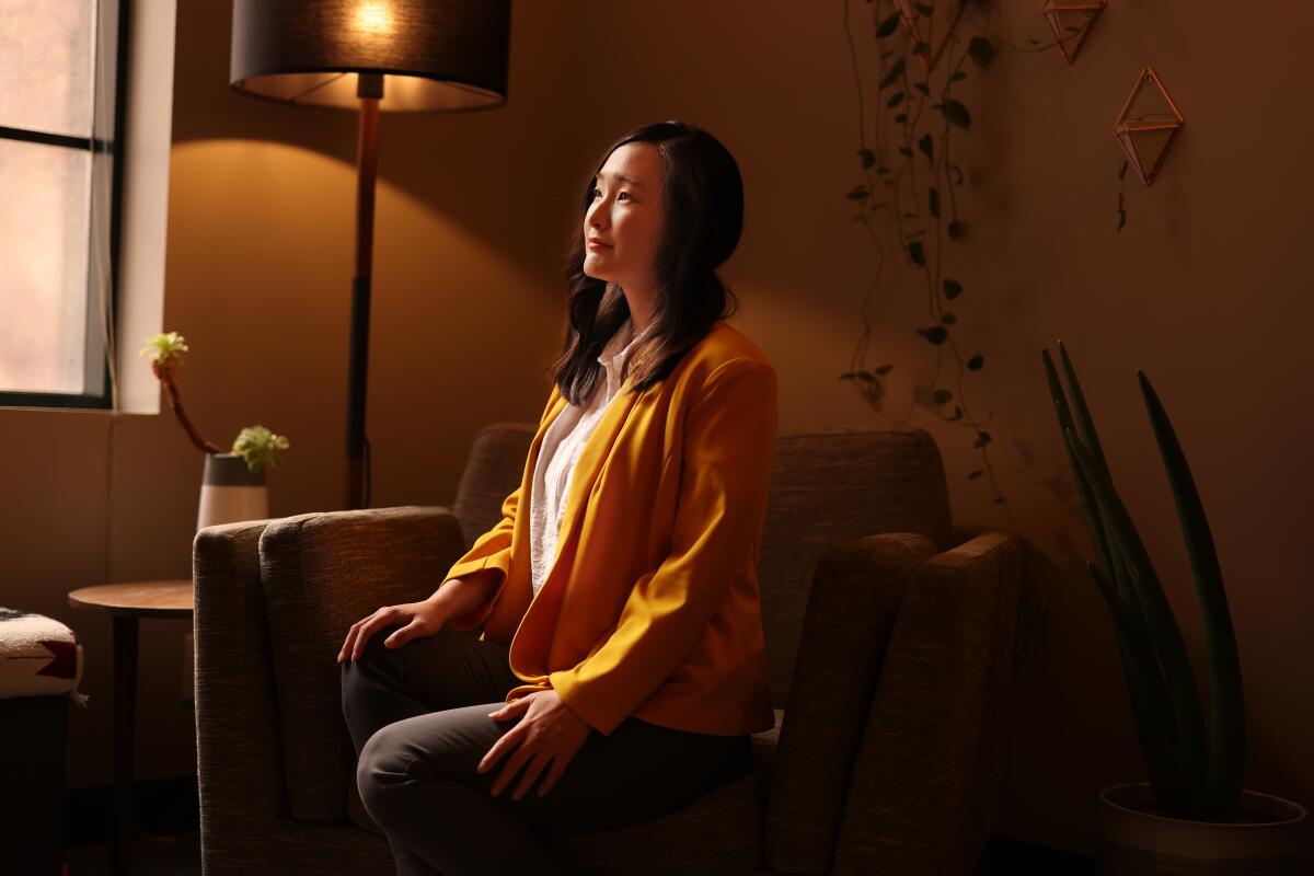 Psychotherapist Linda Yoon sits in an armchair in her downtown L.A. office.